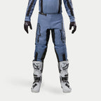 Alpinestars 2024 Fluid Lurv Pants, Motocross Pants, Light Blue and Black, worn with white and black racing boots and matching gloves, featuring bold black star logos on the thighs, ergonomic design for off-road performance