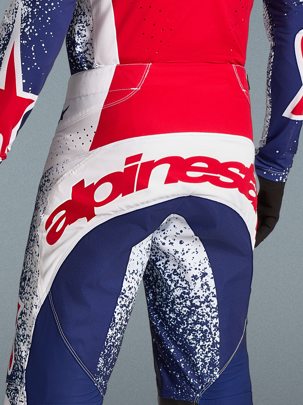 Alpinestars Limited Edition Techstar Unity Gear Set, red and blue motocross pants with bold white logo branding.