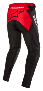 Pantalon Alpinestars Honda Racer Iconic, pantalon de motocross, rouge vif, noir et blanc, vue de trois-quarts arrière montrant le panneau d'assise rouge avec logo étoile noir, marquage Honda blanc sur le côté, construction textile durable à coupe sportive pour la course tout-terrain