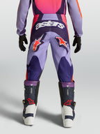 Pantalon Fluid Hunt Junior Alpinestars, pantalon de motocross violet et rose pour enfant avec logos orange, vue de dos.
