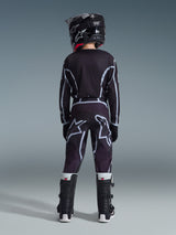 Vue arrière d'un jeune pilote de motocross portant le pantalon Alpinestars Youth Fluid Apex 2026 en noir et gris, maillot à manches longues assorti, casque noir et bottes de motocross noires et blanches, équipement de course tout-terrain coordonné.