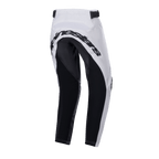Pantalon Alpinestars 2024 Youth Racer Lucent, pantalon de motocross, blanc et noir, vue arrière montrant de larges panneaux renforcés noirs sur l'assise et l'intérieur des jambes, logo Alpinestars à l'arrière et sangles de réglage à la taille pour la conduite tout-terrain.