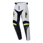 Pantalon Alpinestars Racer Lucent Junior 2024, pantalon de motocross, blanc, noir et jaune fluo, logos étoiles sur les cuisses, panneaux noirs à l'intérieur des jambes et aux genoux, design sportif pré-courbé pour la performance en motocross