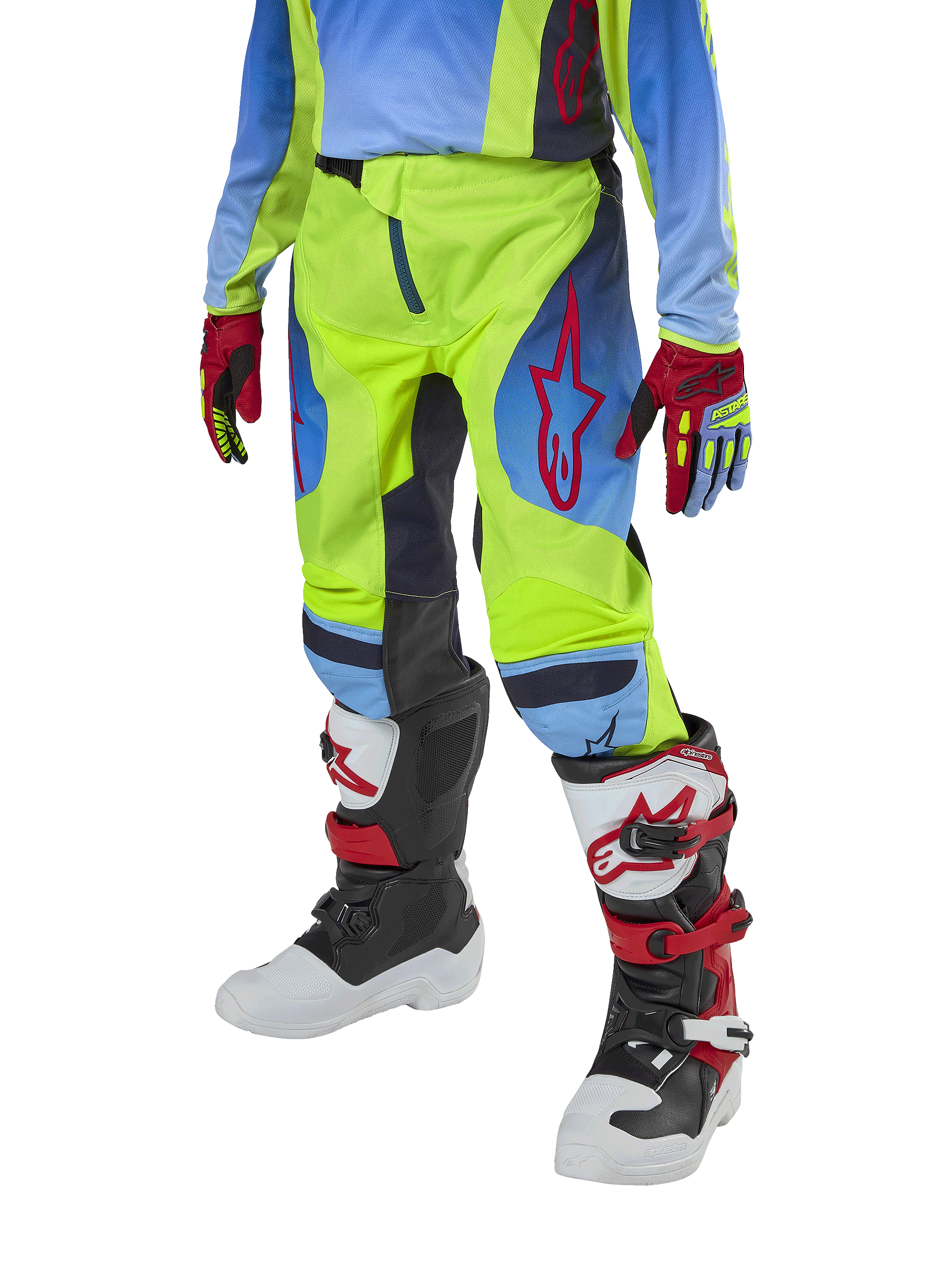 Alpinestars Youth 2024 Racer Hoen Pants, pantalon de motocross pour enfant, jaune fluo et bleu marine avec des accents rouges, porté avec des gants assortis et des bottes blanches, noires et rouges, doté d'une coupe sportive et de jambes pré-courbées pour la course tout-terrain