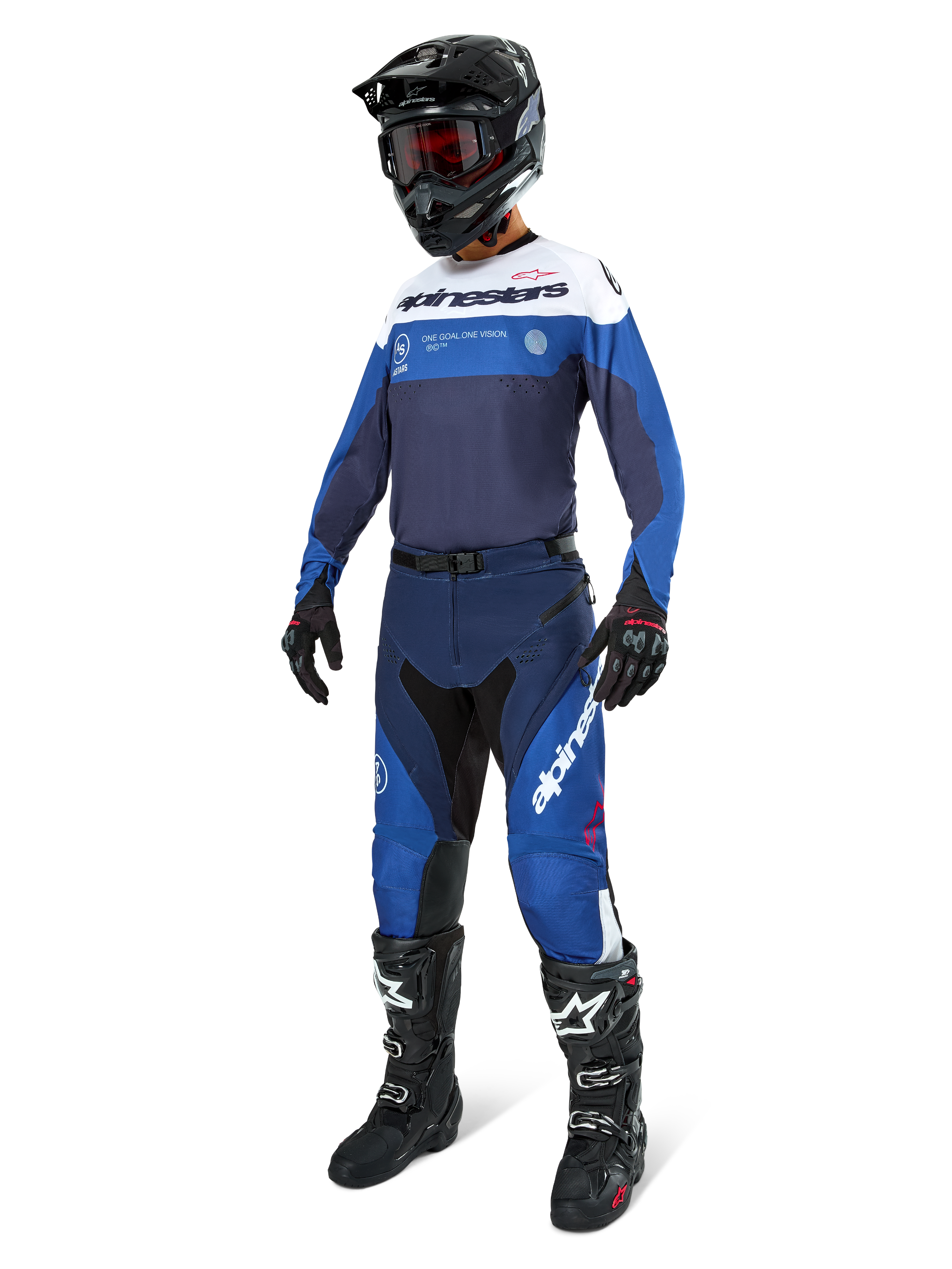 Motocross rider wearing complete racing gear, Pro-Dura Jersey in Navy Bright Blue and White, matching blue and navy pants, black helmet with red goggles, black boots with white accents, and black gloves, coordinated outfit for enduro and off-road riding
