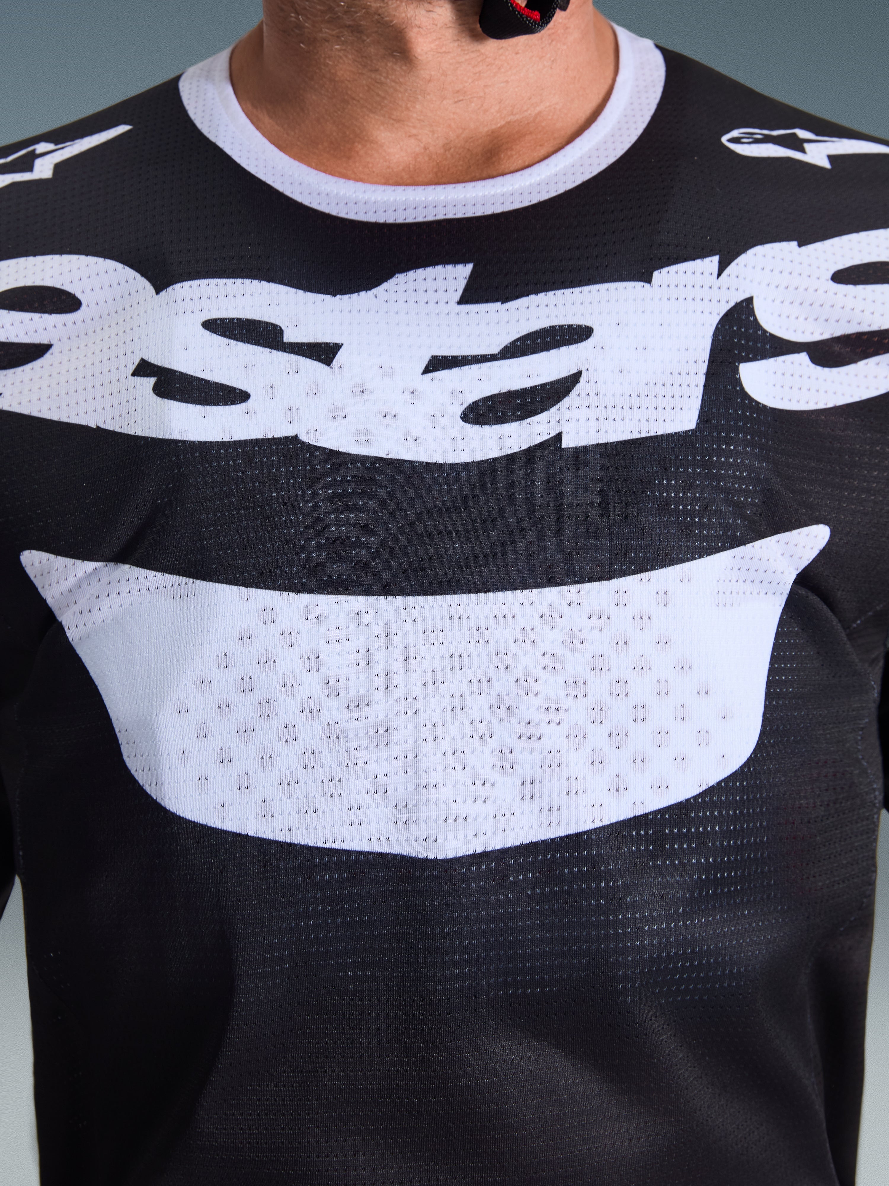 Alpinestars 2026 Racer Air Riway Jersey, Motocross Jersey, Black and White, close-up view of chest with large white logo, detailed mesh airflow fabric texture, technical breathable gear for off-road riding