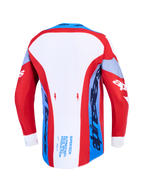 Maillot Alpinestars Supertech Dyna, maillot de motocross rouge, blanc et bleu marine, vue de dos avec ourlet arrière allongé.
