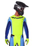 2025 Techstar Melt Jersey, Motocross Racing Jersey, Yellow Fluo and Blue, featuring laser-cut ventilation and athletic race fit, worn by a rider with a black helmet and yellow fluo gloves