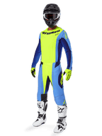 Motocross rider wearing Alpinestars 2025 Techstar Melt Jersey, Yellow Fluo and Blue, paired with matching pants, black helmet with goggles, yellow gloves, and white and black boots, complete coordinated performance gear for off-road racing