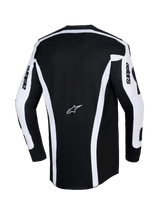 Maillot Alpinestars Racer Riway 2026, maillot de motocross, blanc et noir, vue arrière montrant le design noir avec des bandes verticales blanches et des empiècements sur les manches, logo Astars au centre du dos, texte « astars » sur les manches, coupe arrière allongée pour une couverture optimale en tout-terrain