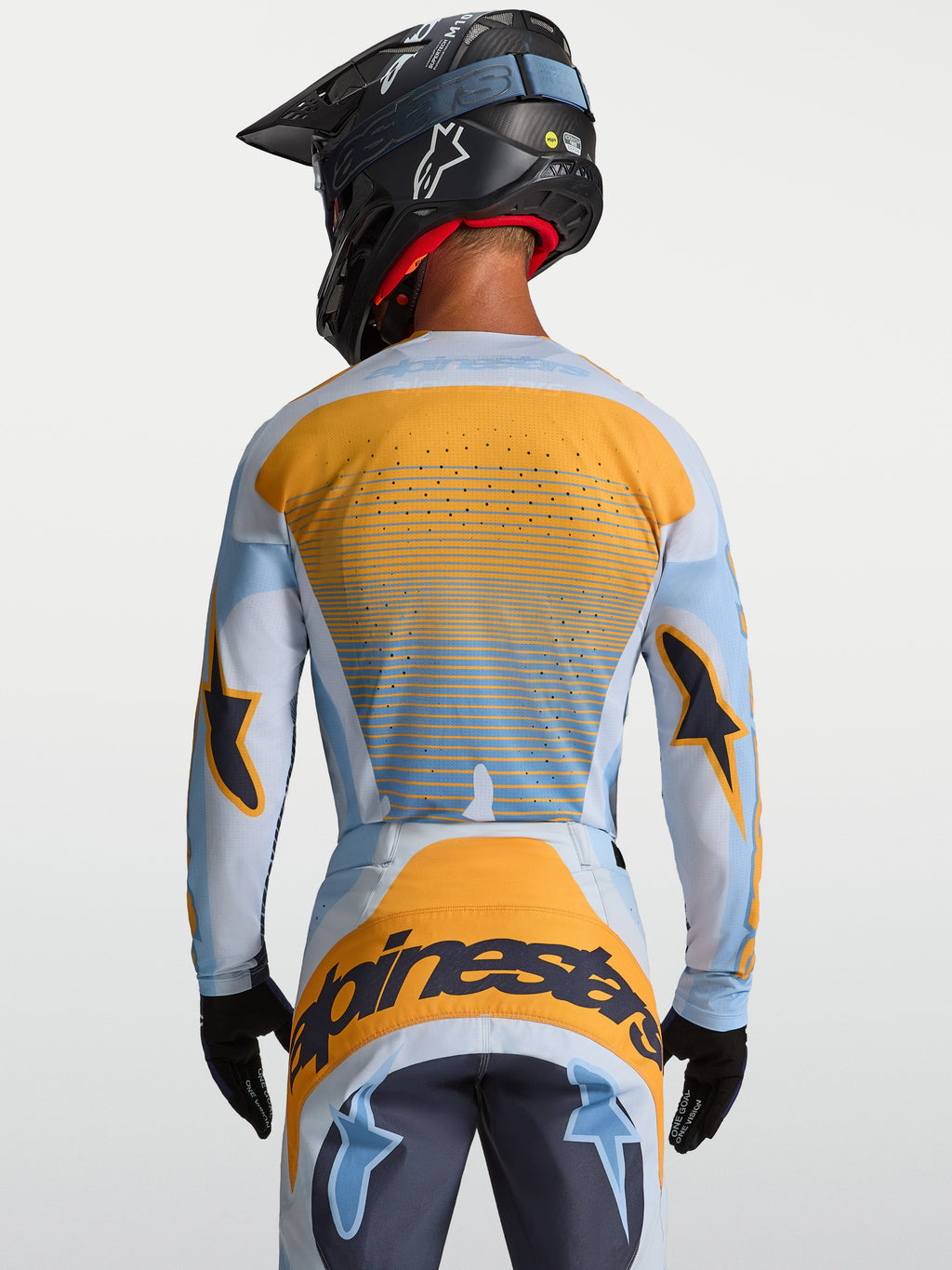 Maillot Techstar Maven Alpinestars, maillot de motocross pour homme, bleu et orange, vue de dos avec perforations laser pour la ventilation.