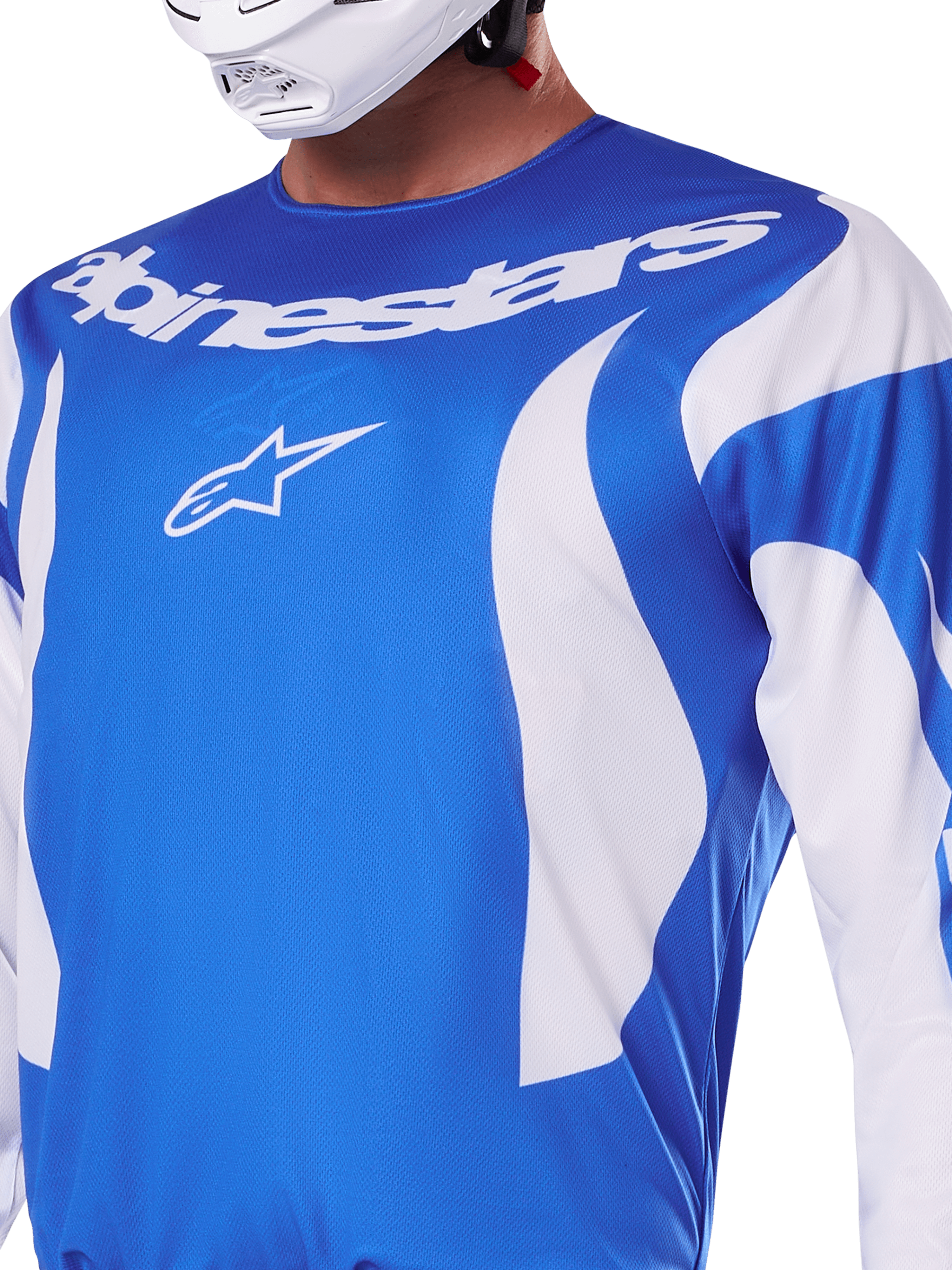 Alpinestars 2025 Fluid Haul Jersey, Blue and White, worn by a rider with a white helmet, featuring a white Alpinestars wordmark and A-star logo, athletic fit, lightweight moisture-wicking material for motocross and off-road riding