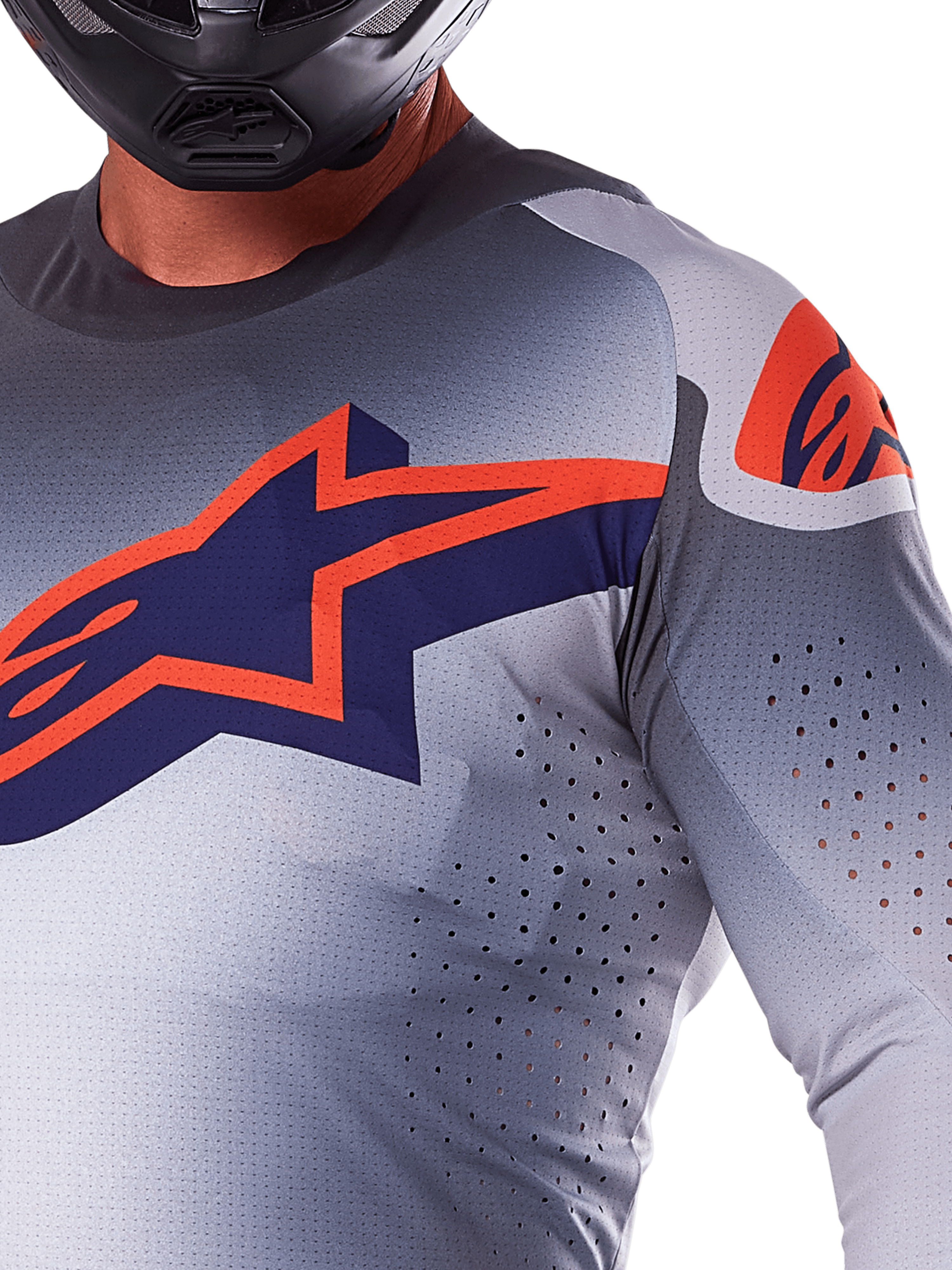 Maillot Alpinestars Supertech Lipan 2025, maillot de motocross gris et orange fluo, arborant un grand logo étoilé bleu marine et orange sur la poitrine, perforations découpées au laser pour la ventilation, construction en maille légère, porté avec un casque noir