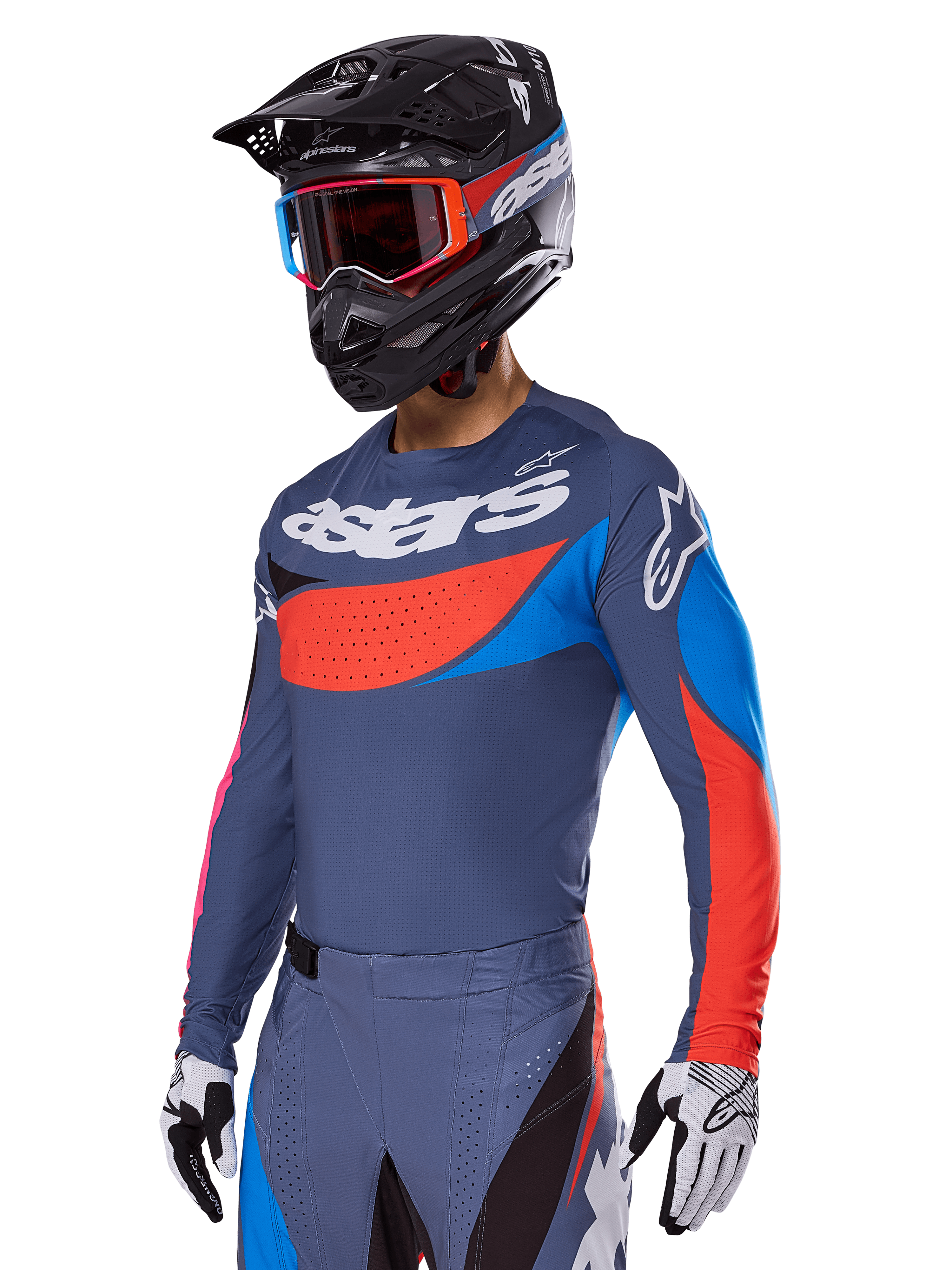 Alpinestars 2025 Techstar Dreem Gear Set, Motocross rider wearing slate gray jersey and pants with bold red and blue graphics, featuring 'astars' branding on the chest, paired with a black helmet, red-framed goggles, and white racing gloves