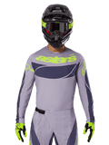 Alpinestars Techstar Dreem 2025, ensemble maillot et équipement de motocross, gris clair et gris foncé avec accents jaune fluo, logo 'astars', avec casque noir, lunettes et gants assortis, matériau technique perforé pour la performance tout-terrain