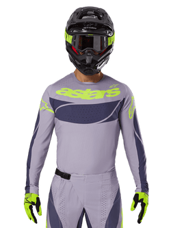 2025 Techstar Dreem Jersey and Gear Set, Motocross racing outfit, light gray and dark gray with neon yellow accents, features 'astars' branding, worn with black helmet, goggles, and matching gloves, technical perforated material for off-road performance