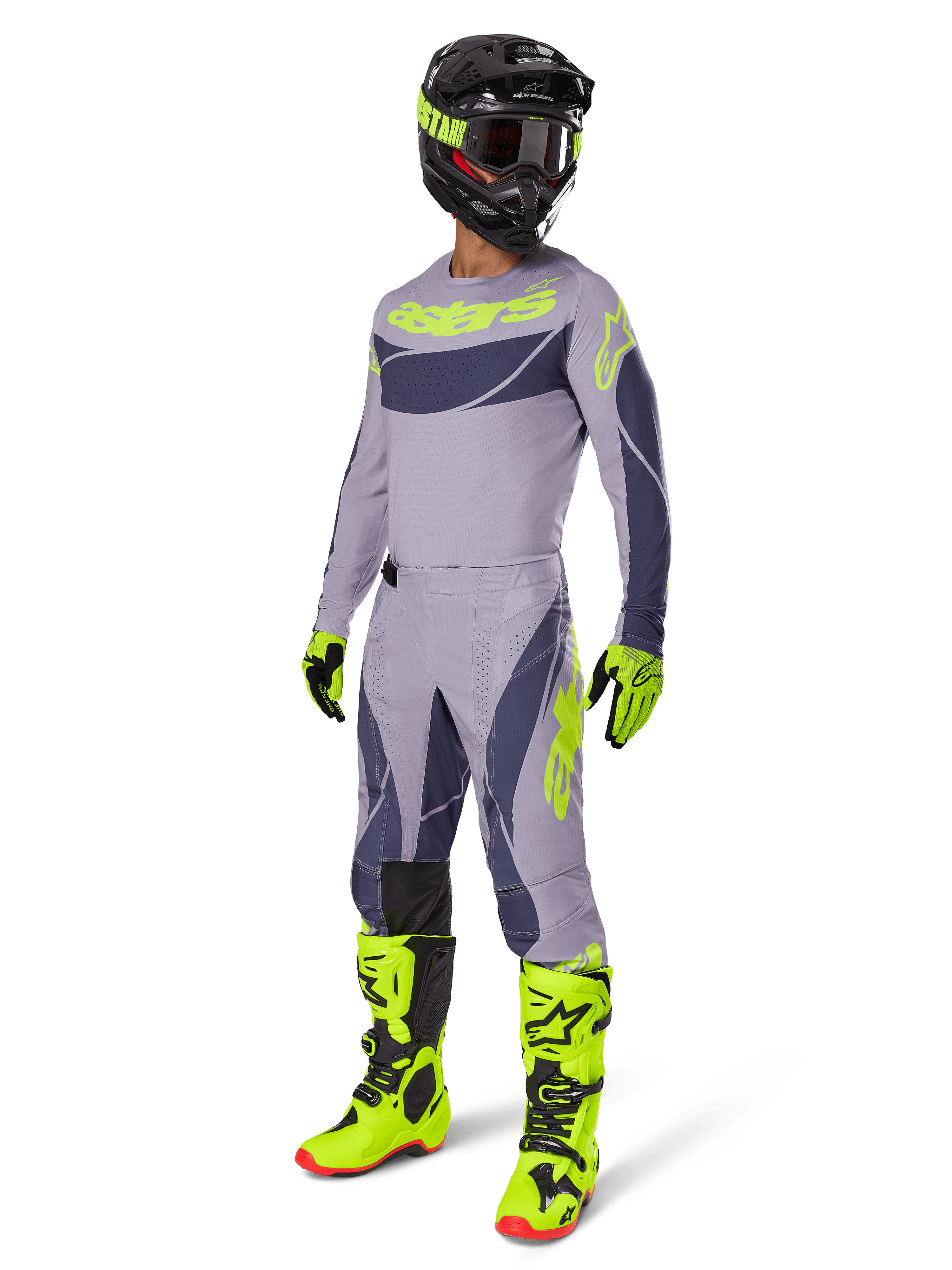 Alpinestars 2025 Techstar Dreem Gear Set, Motocross rider in full racing outfit, gray jersey and pants with dark gray patterns and neon yellow-green accents, matching black helmet, neon yellow-green gloves and boots, performance off-road gear