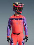 2026 Supertech Scenz Jersey, Motocross Racing Jersey, Hot Coral and Purple, featuring large 'astars' branding and sleeve star designs, worn with matching pants and a multi-colored helmet, high-performance off-road gear