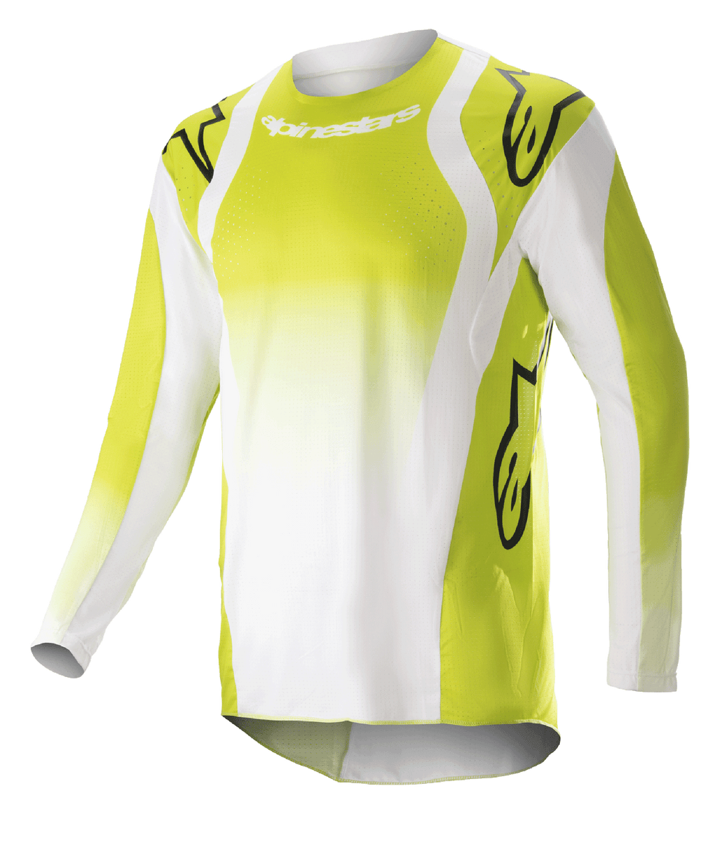 Maillot Alpinestars Techstar Push 2023, maillot de motocross à manches longues, jaune fluo et blanc, avec de grands logos Astars noirs sur les épaules et les manches, tissu technique perforé, col rond et pan arrière rallongé pour la course tout-terrain