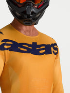 Maillot Racer Amber Alpinestars orange et bleu foncé, maillot de motocross respirant avec logo Astars sur la poitrine.
