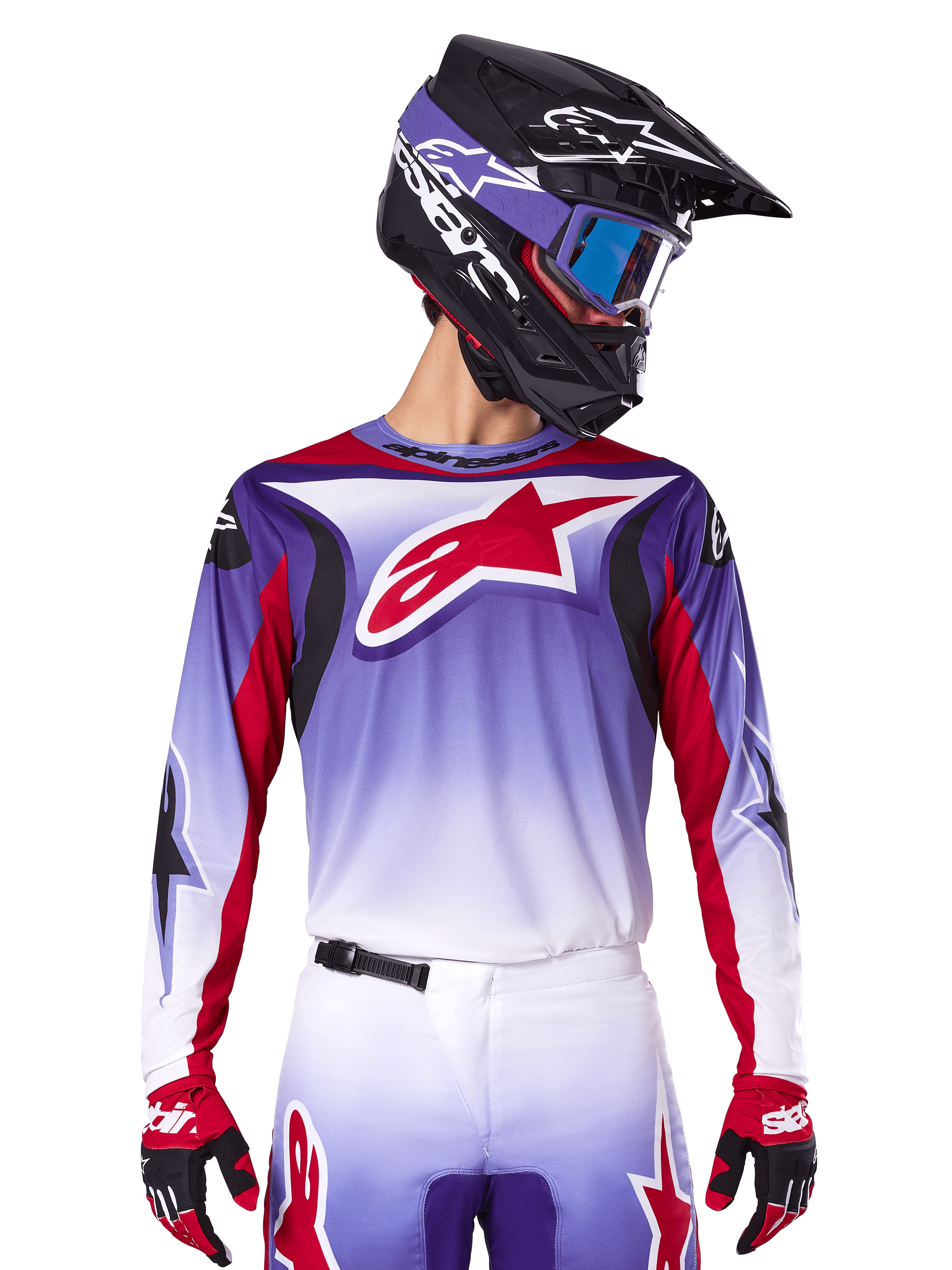 Maillot Alpinestars Fluid Wurx 2025, maillot de motocross, dégradé du violet au blanc, logo étoile rouge et accents rouges, coupe athlétique, porté avec le pantalon assorti, un casque noir et des gants rouges