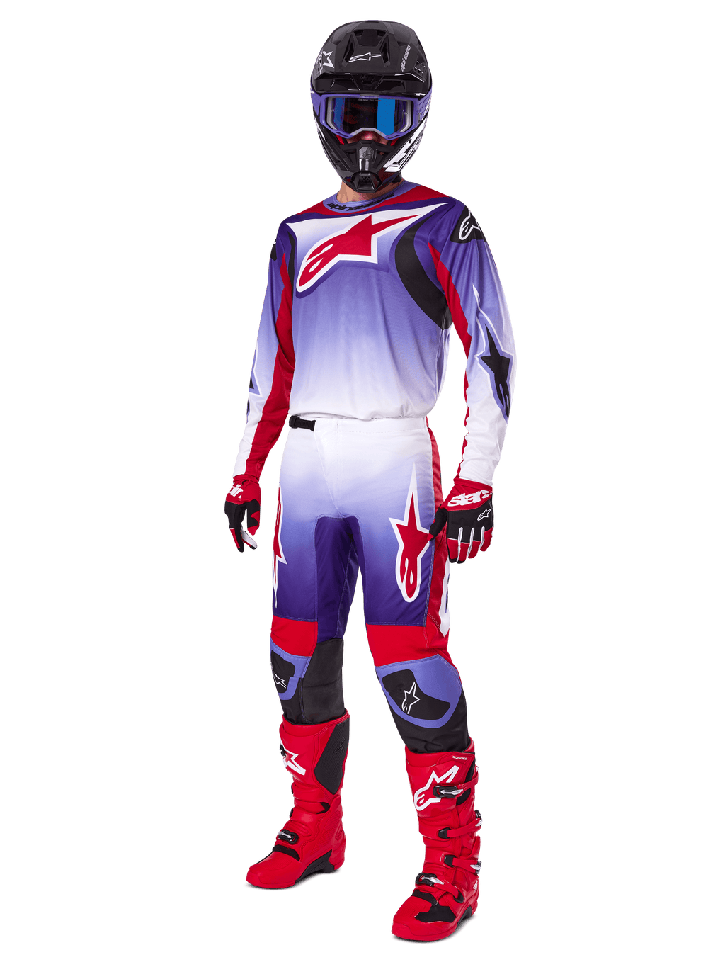 Pilote de motocross portant l'ensemble Alpinestars 2025 Fluid Wurx, maillot violet et rouge vif avec des accents blancs, pantalon de motocross assorti, bottes rouge vif, casque noir avec lunettes bleues et gants rouges et noirs, tenue complète de course tout-terrain professionnelle