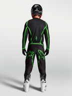 Alpinestars Fluid Apex V2 Pants, Black and Green Fluo motocross gear shown from behind on a rider with white boots.
