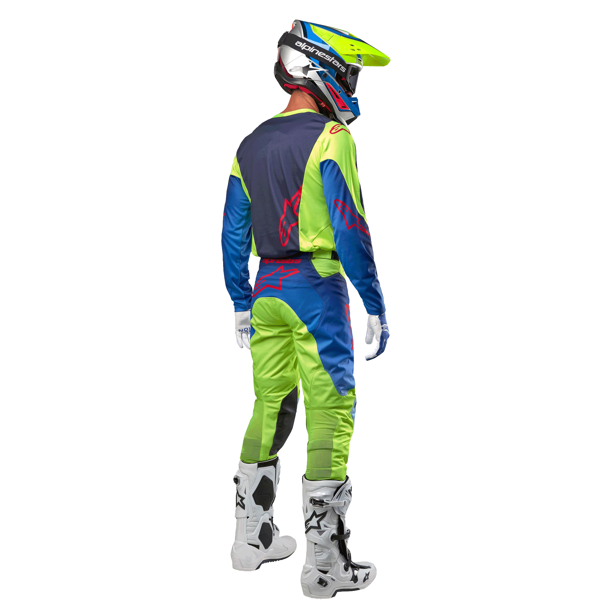 Motocross rider from behind wearing the Alpinestars 2024 Racer Hoen Jersey in Yellow Fluo and Blue Night Navy, matching motocross pants and white boots, showing the rear design with red logos, coordinated outfit for professional off-road racing