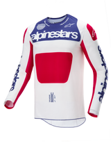 Maillot Alpinestars Techstar Fortitude Édition Limitée, maillot de motocross, rouge, blanc et bleu, avec un corps blanc, un large panneau central rouge, une section bleue sur la poitrine avec marquage Alpinestars blanc et des logos bleus sur les manches, conçu pour la performance en course tout-terrain