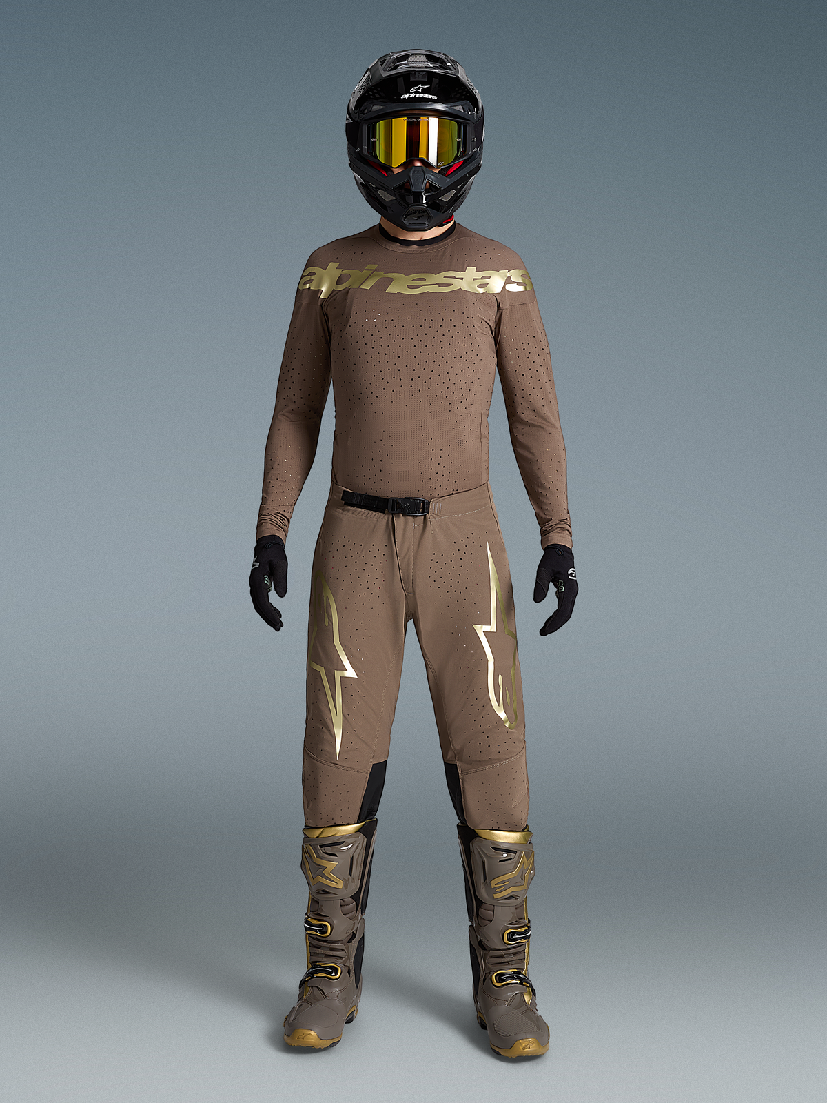 Tenue Supertech Air Or Édition Limitée, ensemble motocross beige aux logos dorés, bottes et casque assortis.