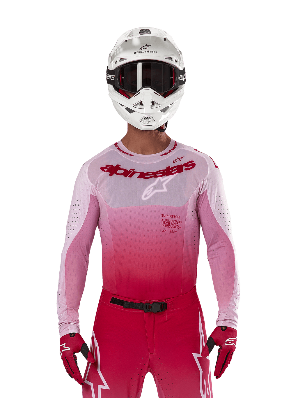 Pilote de motocross portant le maillot Alpinestars Supertech Dade 2024 en Red Berry Lilac, pantalon assorti, casque blanc avec lunettes noires et gants rouges, tenue de course professionnelle coordonnée avec des tons dégradés de rose et de rouge