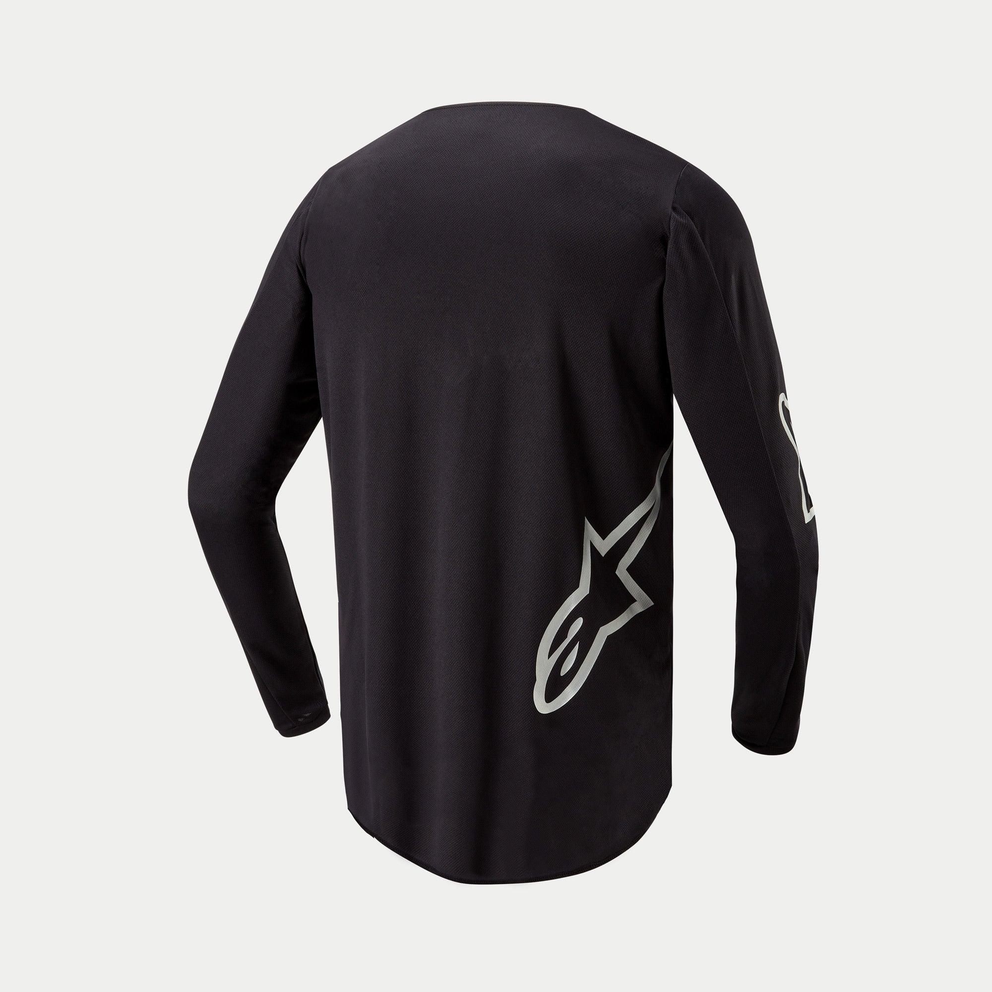 Maillot Alpinestars Fluid Graphite 2024, maillot de motocross, noir et argent, vue de dos avec logo étoile argentée sur le côté inférieur, conception à manches longues avec pan arrière allongé pour une meilleure protection en tout-terrain