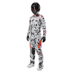 Motocross rider wearing Alpinestars 2024 Techstar Rantera Jersey in Haze Gray Camo, matching pants with red and black accents, black helmet and goggles, black gloves, white and black boots, complete coordinated motocross racing gear for off-road performance