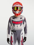 Alpinestars Supertech Swan Junior, tenue de motocross racing grise et rouge fluo en maille extensible respirante.
