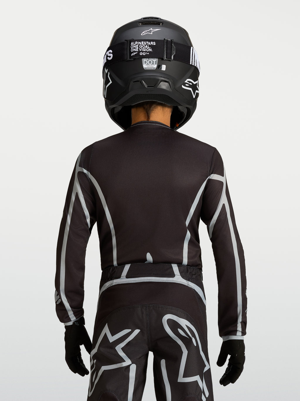 Maillot Alpinestars Fluid Apex V2 Junior, haut de motocross noir et argenté, vue de dos avec coupe ergonomique pour enfant