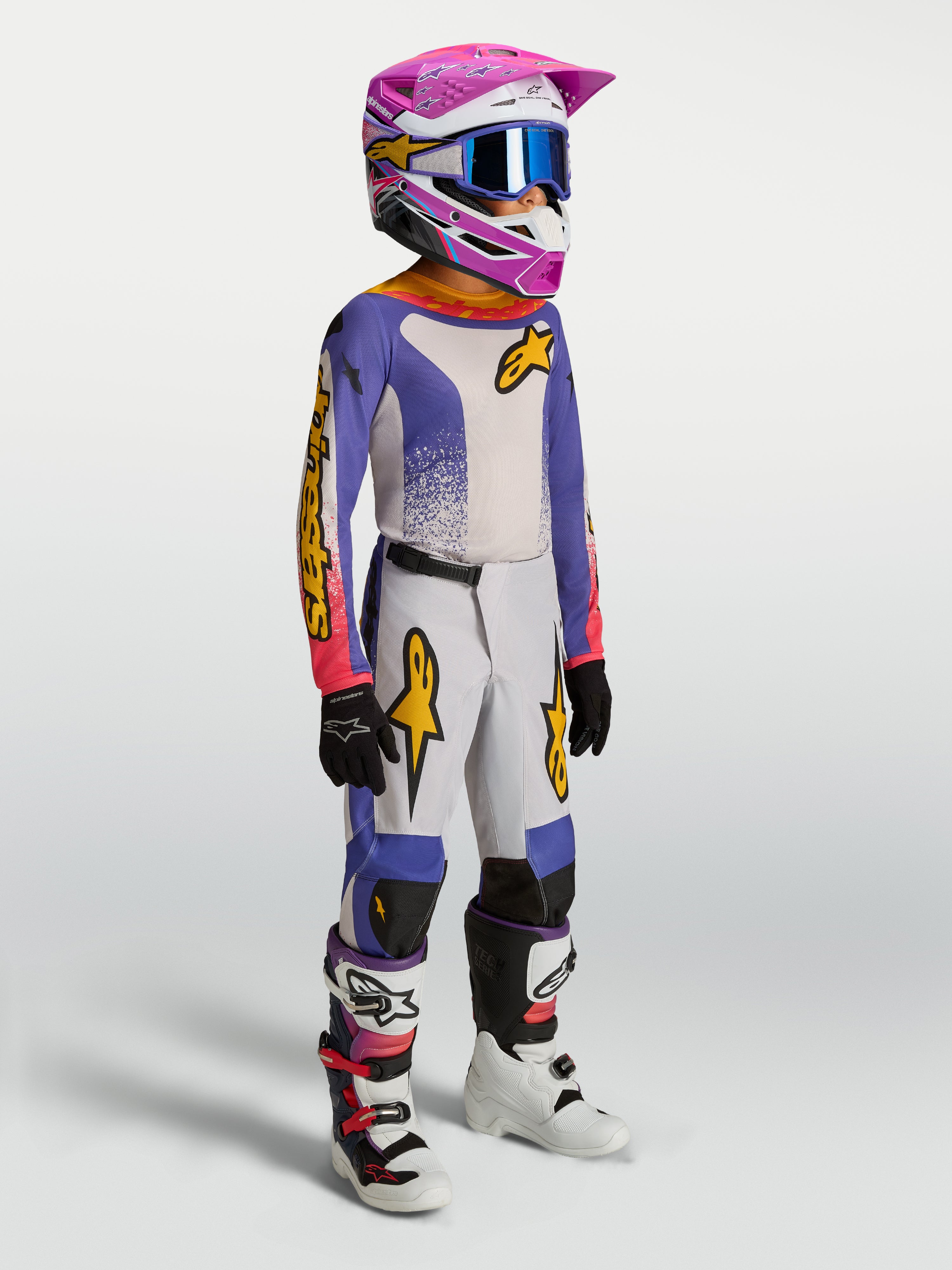 Ensemble Alpinestars Junior Fluid Drag, tenue de motocross enfant, bleu et blanc avec accents roses et dorés, style course.