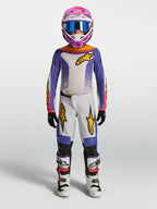 Alpinestars maillot et ensemble Fluid Drag Junior 2027, tenue de motocross pour enfant, violet et blanc avec accents dorés.
