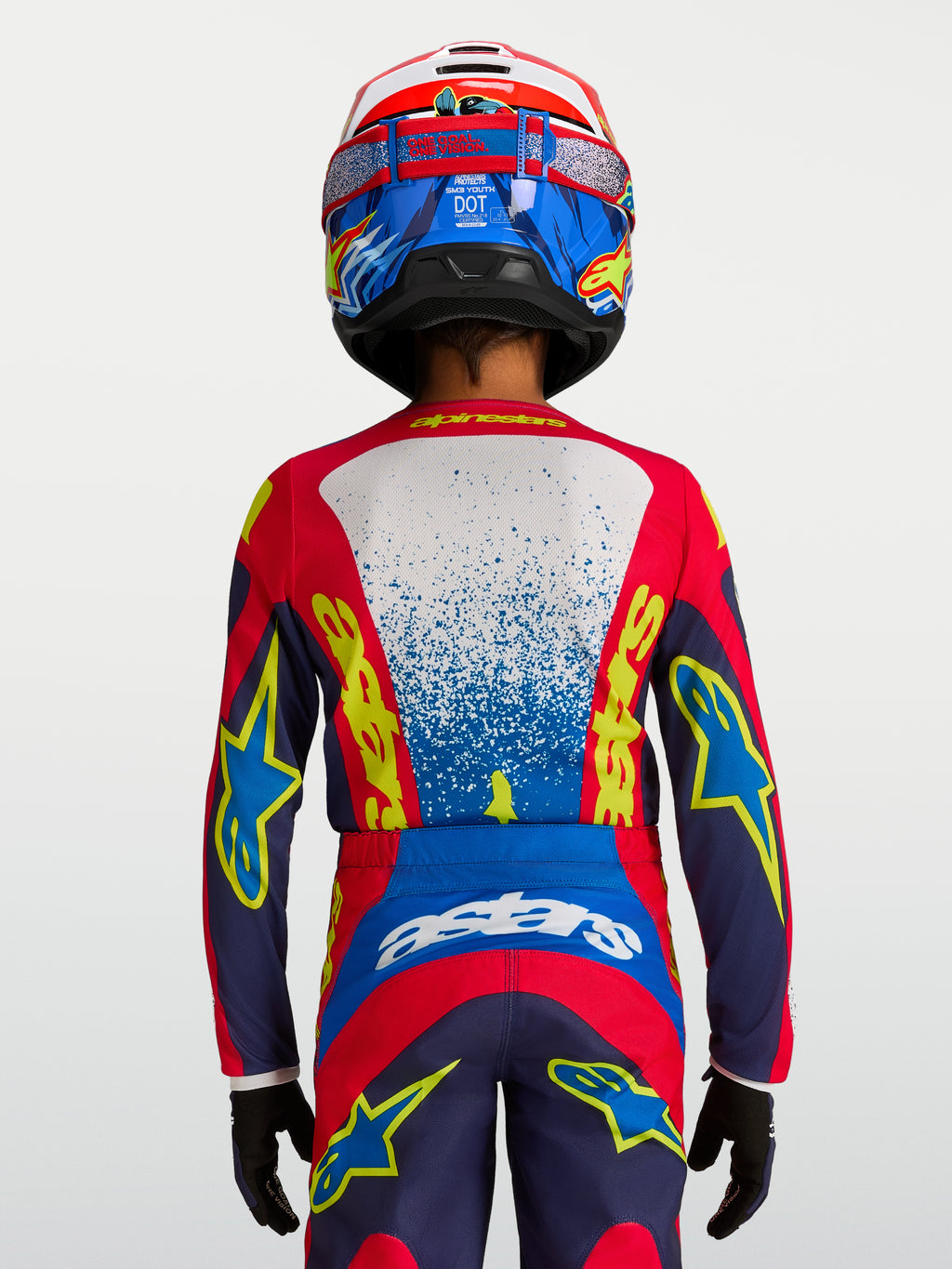 Maillot Fluid Drag Junior Alpinestars, haut de motocross pour enfant, bleu et rouge, coupe ergonomique, vue de dos.