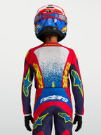 Maillot Fluid Drag Junior Alpinestars, haut de motocross pour enfant, bleu et rouge, coupe ergonomique, vue de dos.