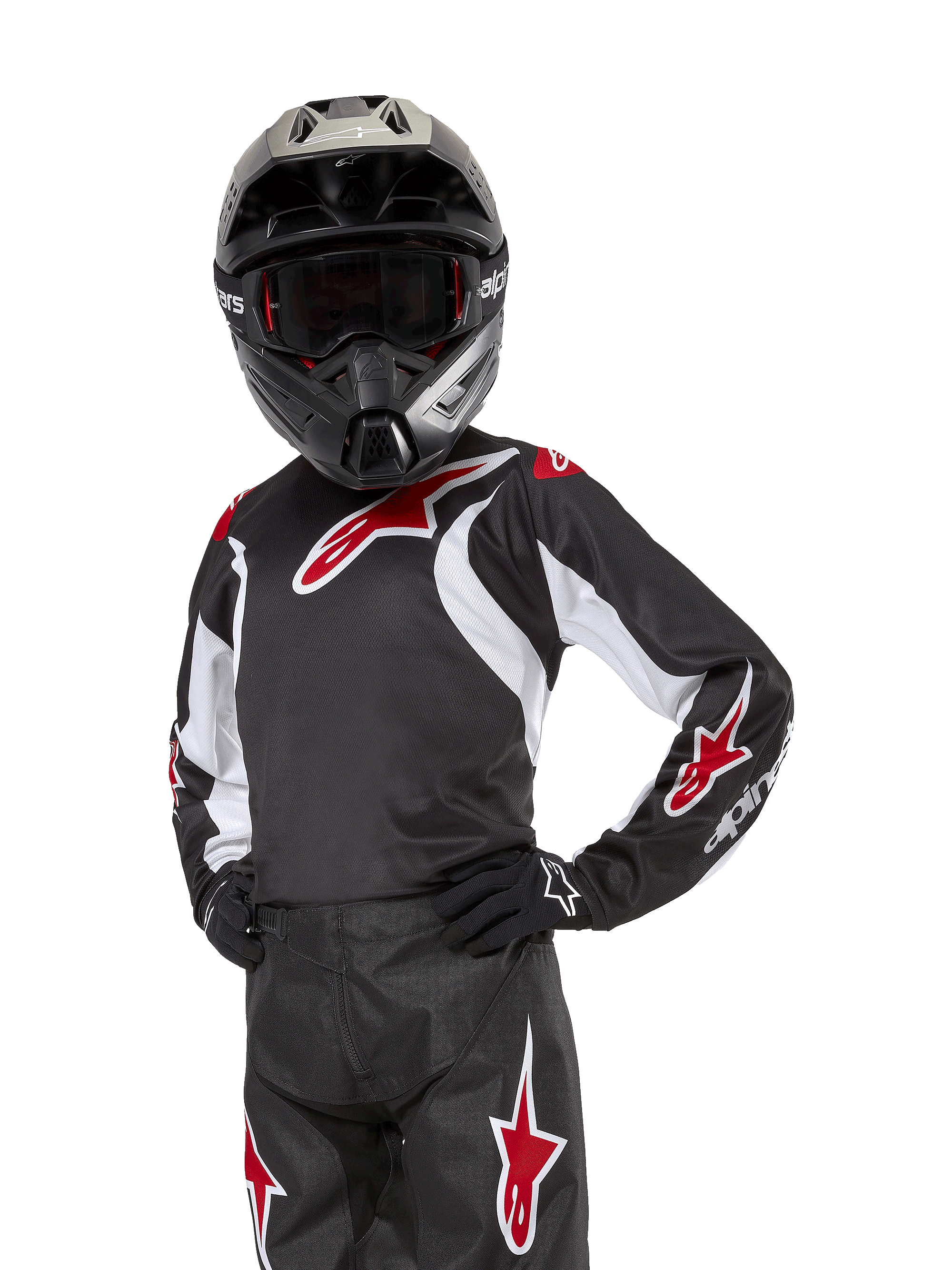 Maillot Racer Lucent Junior 2024, maillot de motocross, noir, blanc et rouge, porté par un jeune pilote avec un casque noir et un pantalon assorti, arborant des logos d'étoiles rouges et des accents graphiques blancs, équipement de performance tout-terrain pour la course de motocross