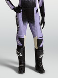Alpinestars Stella Techstar Swan, pantalon de motocross pour femme, violet et noir avec accents en cuir crème, porté avec des bottes tout-terrain noires