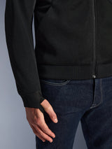 Alpinestars Chrome Superairflow Hoodie, Black, close-up of high-resistance 3D technical mesh fabric, featuring ribbed stretch jersey cuff with elastic retention thumb loop, worn with blue jeans