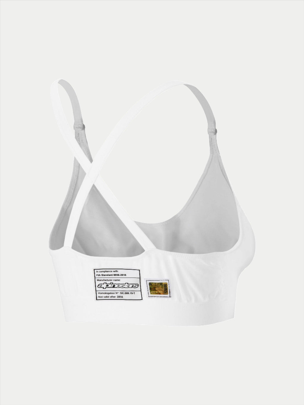 Brassière Alpinestars Stella TECH ZX, sous-vêtement de course blanc résistant aux flammes, vue arrière montrant la conception des bretelles croisées, avec étiquette d'homologation FIA 8856-2018 et hologramme, couche de base légère et performante pour femmes