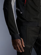 Alpinestars Troop-Air Pro Jacket, premium armored air jacket, Black Ash Gray and Bright Red, featuring 2D tech mesh construction for ventilation, ash gray sleeve panels, red zipper accent, and integrated thumbhole cuffs, worn with matching pants.