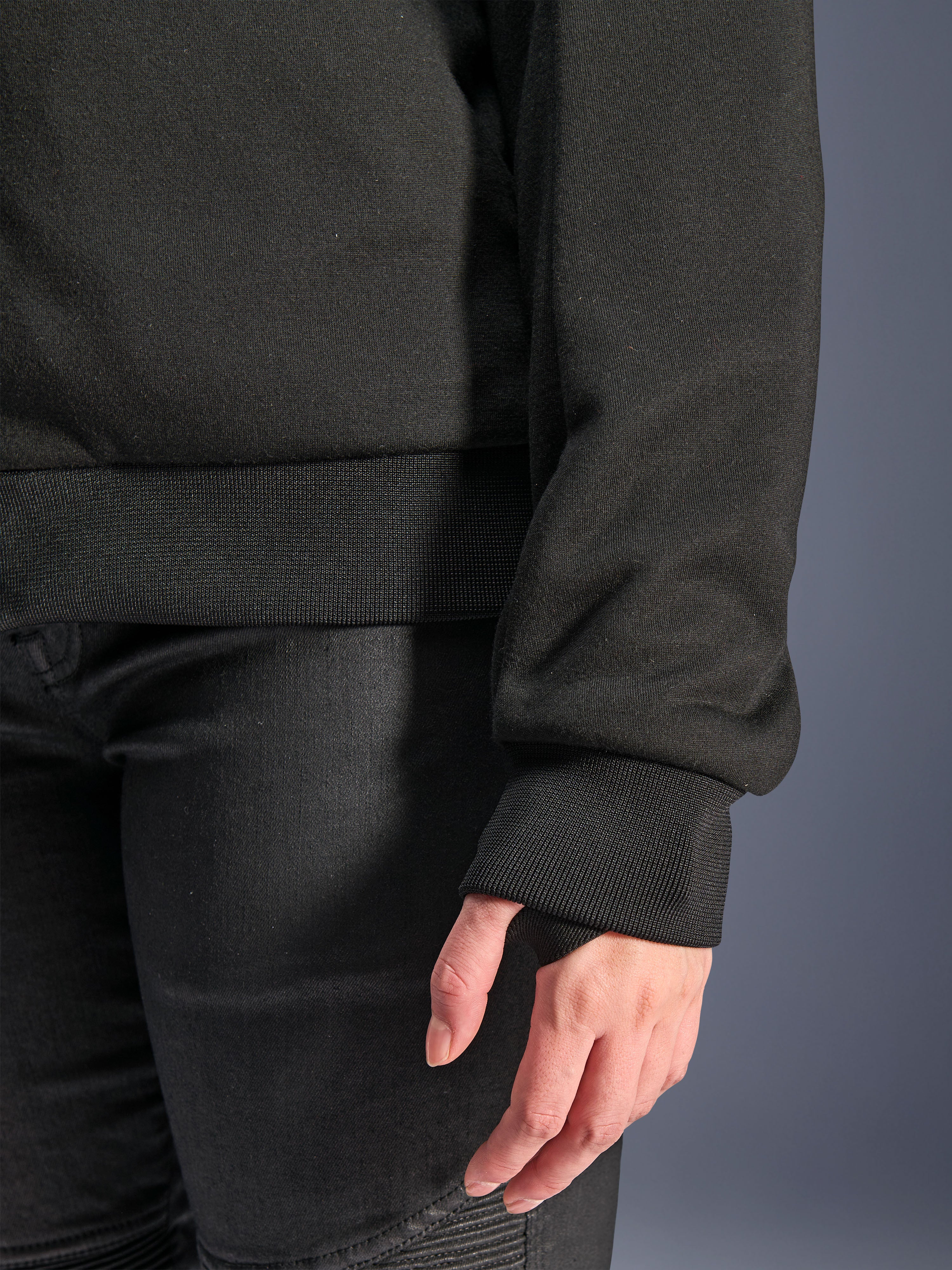 Alpinestars Stella Chrome V2 Sport Hoodie, Black, close-up of ribbed sleeve cuff with thumb hole and ribbed waist hem, tech fleece material for urban motorcycle riding