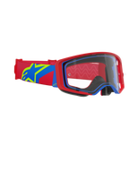 Masque Alpinestars Supertech Corp, masque de motocross, monture rouge et bleue avec écran clair, bandeau rouge et bleu arborant un grand logo étoile jaune et bleu, protection oculaire professionnelle pour la course tout-terrain