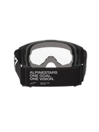 Masque Alpinestars Vision OTG, masque de motocross, noir et gris, vue arrière montrant une large sangle tissée noire avec le slogan de la marque, mousse faciale multicouche grise, écran clair, conçu pour être porté par-dessus des lunettes de vue