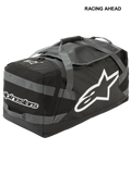 Sac Goanna Alpinestars, sac de sport motocross, noir et gris anthracite avec logos blancs, doté d'un grand logo étoile latéral et du nom de la marque, base en bâche résistante, sangles de transport renforcées, grand espace de rangement pour l'équipement tout-terrain