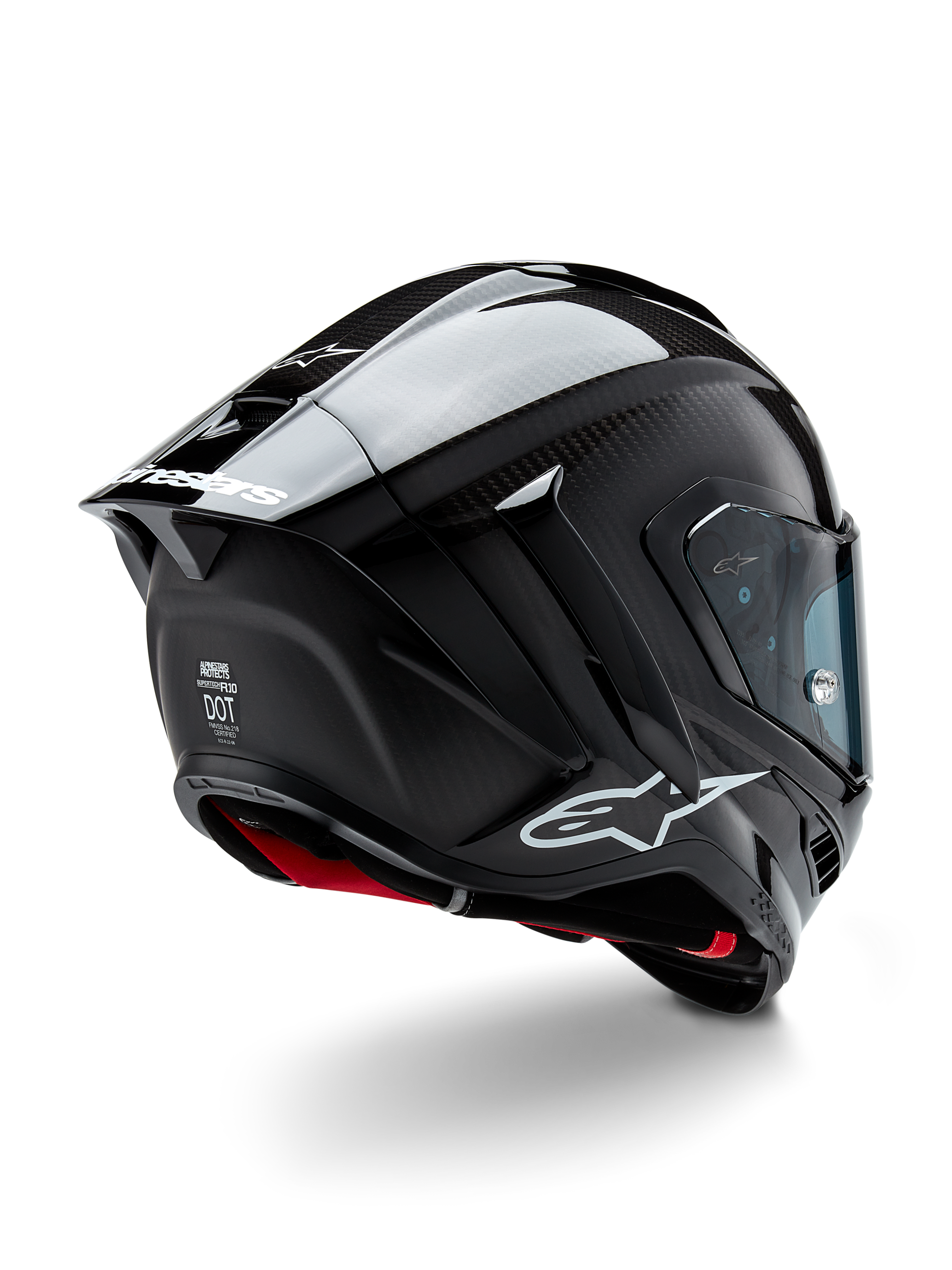 Casque Alpinestars Supertech R10 Solid, casque de course moto, finition carbone noir mat et brillant, vue de trois-quarts arrière montrant la coque en fibre de carbone, le spoiler aérodynamique et le logo Alpinestars.