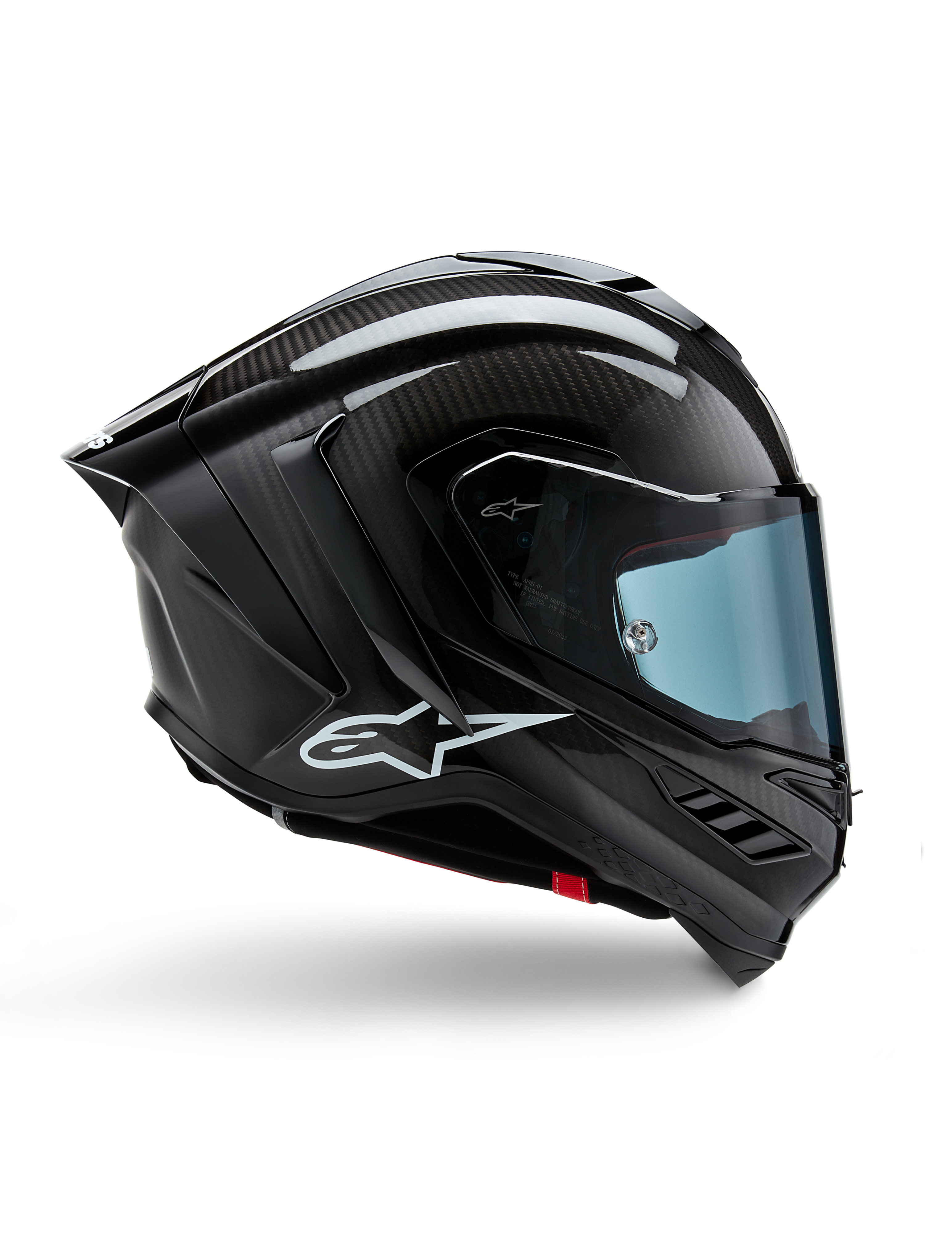 Alpinestars Supertech R10 Solid, casque de moto de course, carbone noir mat et brillant, construction en fibre de carbone, profil latéral, visière teintée bleue, design aérodynamique avec ailerons, logo blanc, protection haute performance de niveau MotoGP